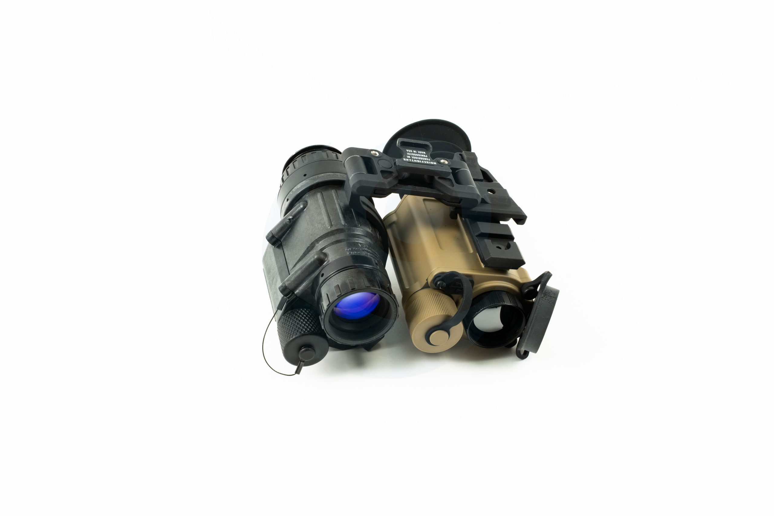 Dual night vision goggles with black and tan housings on a white background.
