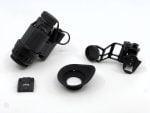 Night vision scope and accessories on a white background