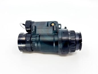 Side view of a black night vision monocular device with adjustment knobs on white background