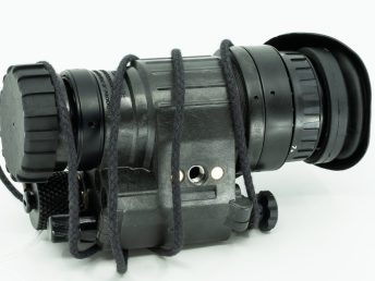 Night vision monocular device with black cord against white background