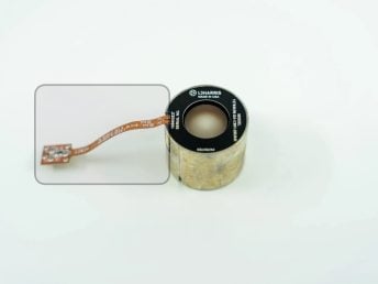 L3Harris night vision tube with attached circuit board on a white background.