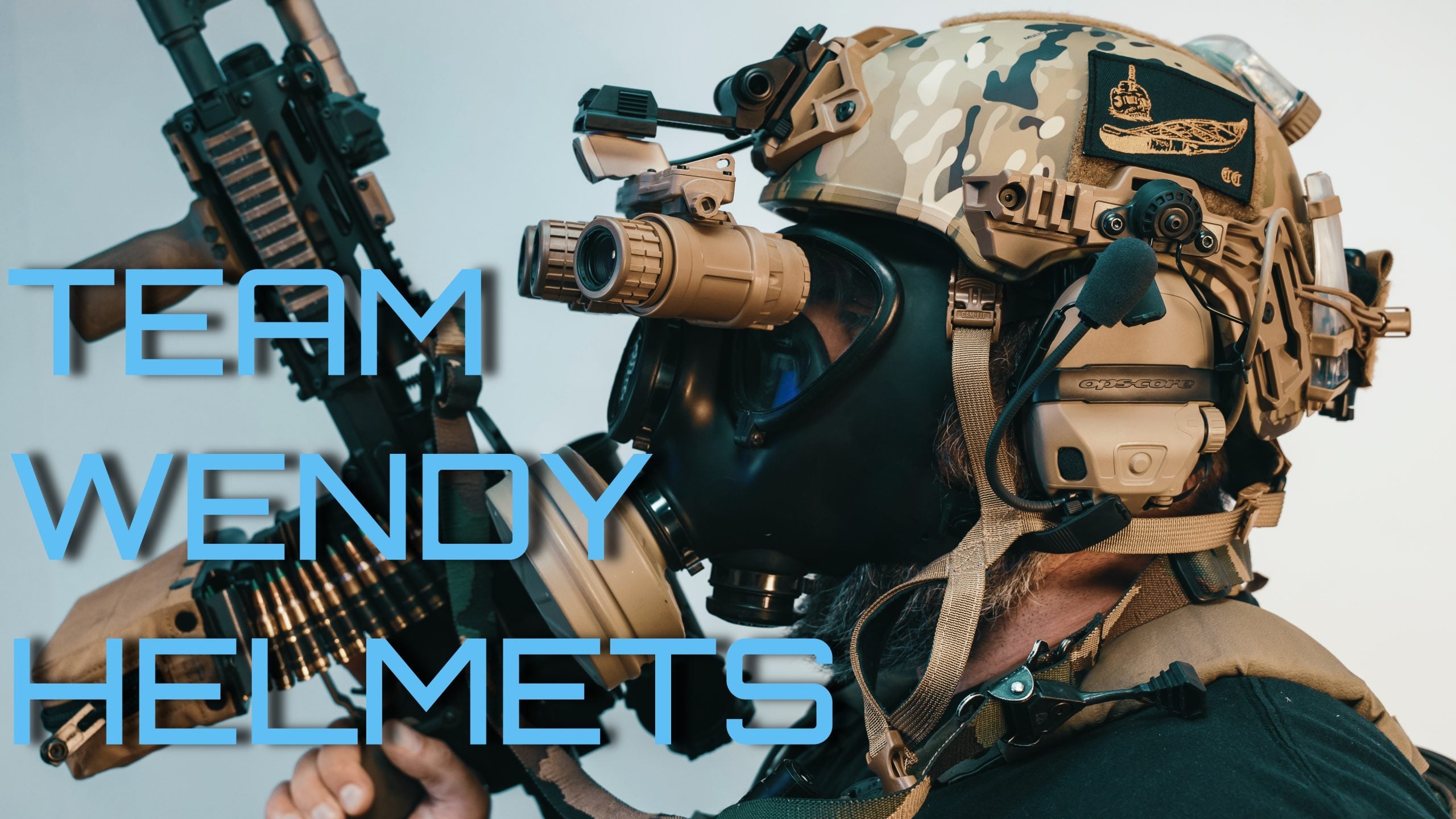 Person wearing tactical helmet with night vision headset and camo gear holding a firearm.