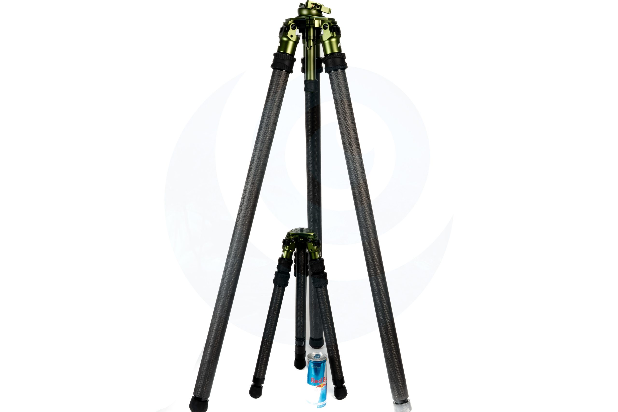 Two carbon fiber tripods of different sizes with a Red Bull can for scale.