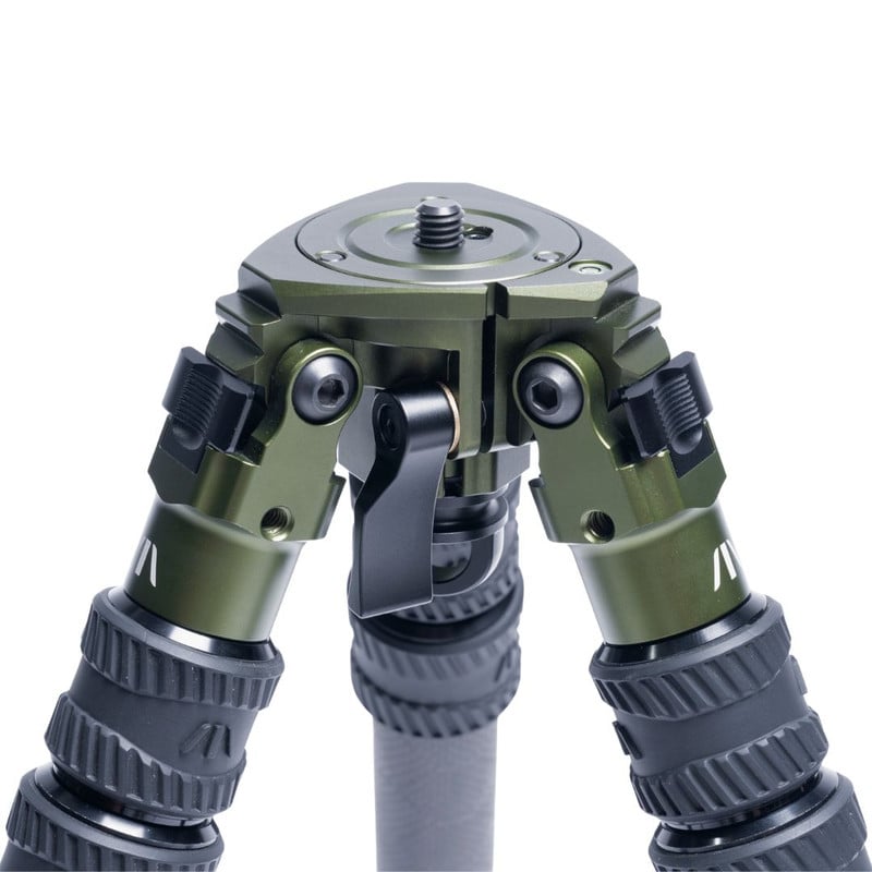 Close-up of a green and black tripod head with adjustable legs and locking mechanisms.
