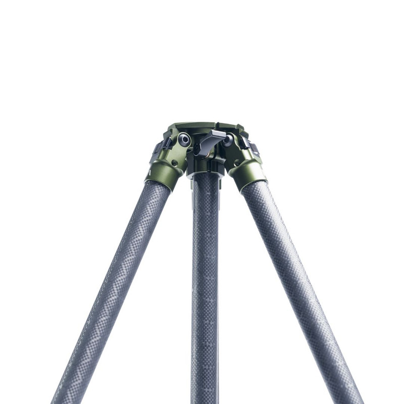 Close-up of a carbon fiber tripod with green metal joints against a white background.